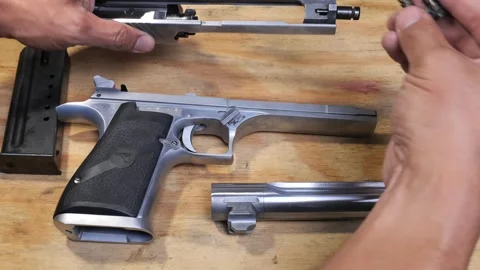 Assembly of a field stripped Desert Eagle pistol and then function check Video stock 252026190