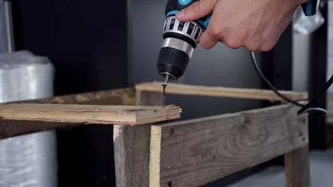 Assembly of the frame for sending fragile cargo, tightening screws Stock Footage 112340952