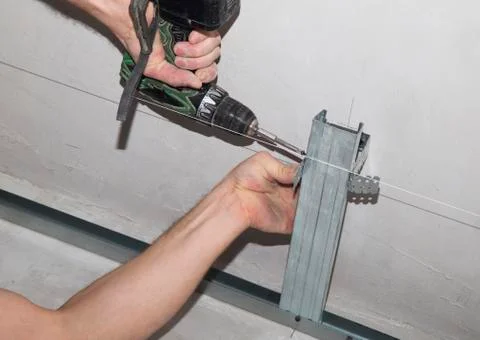 Assembly of a framework for a plasterboard ceiling Stock Photos