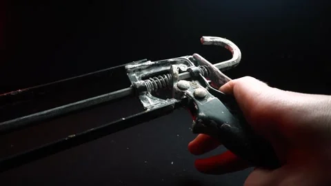 Assembly gun for sealants for construction work in red light Video stock 302340413
