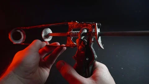Assembly gun for sealants for construction work in red light 스톡 동영상 302340430