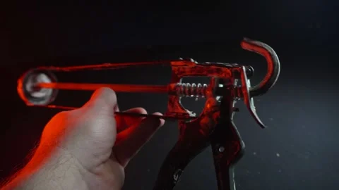 Assembly gun for sealants for construction work in red light Video stock 302340456