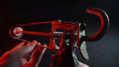 Assembly gun for sealants for construction work in red light Stockbeeldmateriaal 302340510