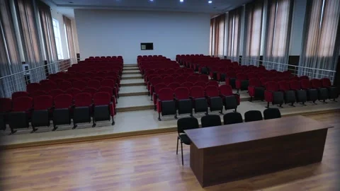 Assembly hall, red chairs, white ceiling, pan around Stock Footage 163085471