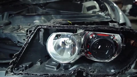 Assembly of the headlight after repair and replacement of bulbs 스톡 동영상 303957767