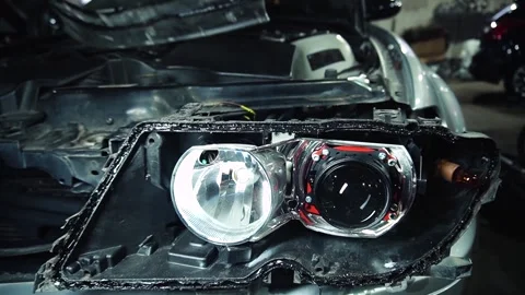 Assembly of the headlight after repair and replacement of bulbs 스톡 동영상 303957770