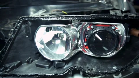 Assembly of the headlight after repair and replacement of bulbs 스톡 동영상 303957786