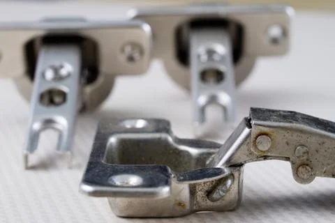 Assembly of hinges in a carpentry workshop. Joinery accessories in a carpentr Stock Photos