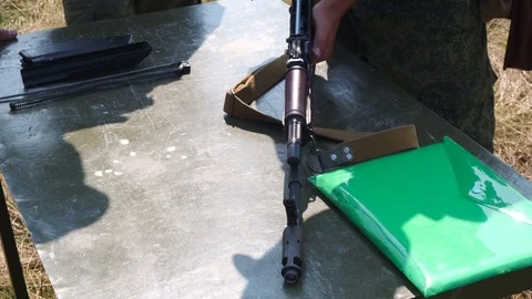 Assembly of a Kalashnikov assault rifle. Unlocking assault rifle. Collection of Stock Footage 118375476