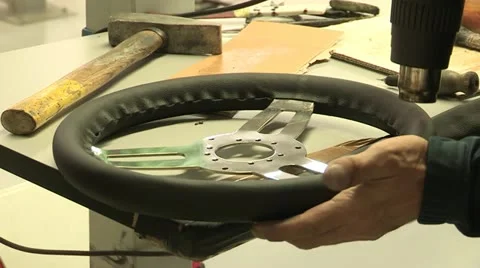 Assembly of a leather steering wheel Stock Footage 22413854