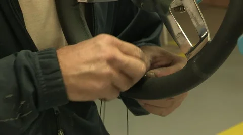 Assembly of a leather steering wheel Stock Footage 22413859
