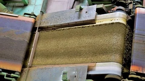 Assembly line of processing of tea leaves by machines from raw material leave Stock Photos