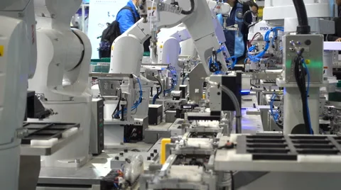 Assembly line robots on display at a technology fair in Shanghai, China Stock Footage 60688075