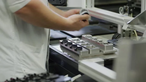 Assembly line work in Production Plant - Handiwork at conveyor belt in Factory Stock Footage 167131955