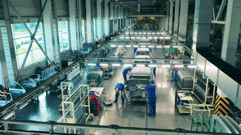 Assembly line workers mount car details in auto body shop Video stock 142220613