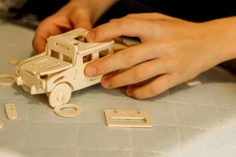 Assembly of the machine model from a wooden constructor Fotos de archivo