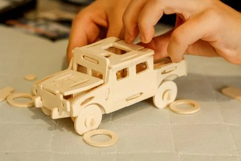 Assembly of the machine model from a wooden constructor Stock Photos