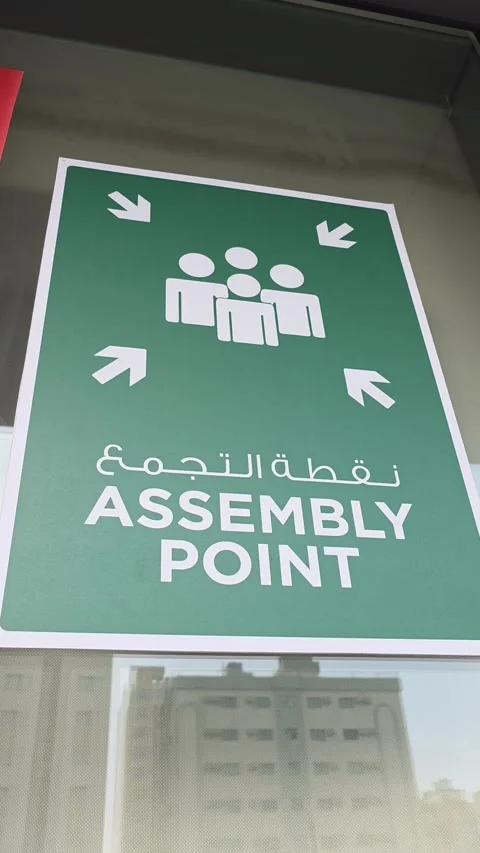 Assembly point signboard displayed outside a building Stock Footage 320998945