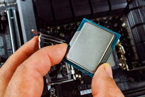 Assembly process of a desktop computer involves technician plugging CPU into 스톡 사진