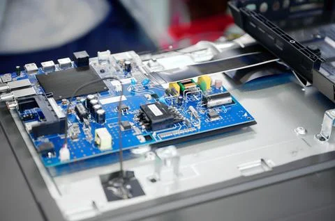 Assembly process of electronic components at television production facility Stock Photos