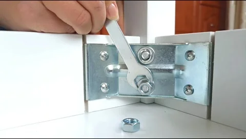 Assembly of table frame by attaching table leg with metal brackets,bolts and nut Stock-Footage 339178007