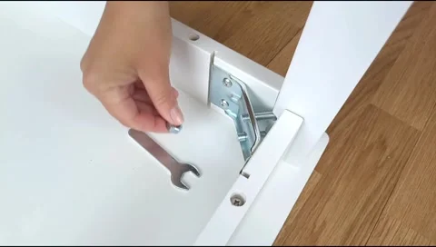 Assembly of table frame by attaching table leg with metal brackets,bolts and nut Stock Footage 339178009