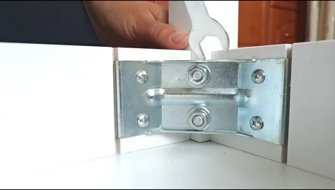 Assembly of table frame by attaching table leg with metal brackets,bolts and nut Stock Footage 339178012