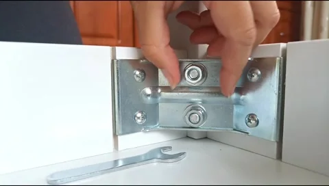 Assembly of table frame by attaching table leg with metal brackets,bolts and nut Stock Footage 339178013