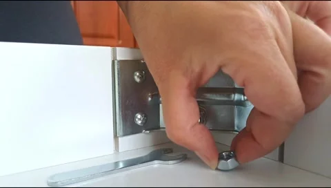 Assembly of table frame by attaching table leg with metal brackets,bolts and nut Stock Footage 339178162