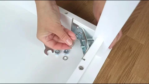Assembly of table frame by attaching table leg with metal brackets,bolts and nut Stock Footage 339178259