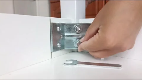Assembly of table frame by attaching table leg with metal brackets,bolts and nut Stock Footage 339178402