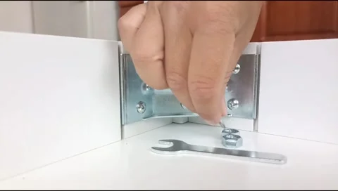 Assembly of table frame by attaching table leg with metal brackets,bolts and nut Stock Footage 339178424