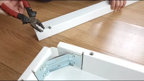 Assembly of a table leg using metal fasteners, connector pins Stock Footage 339180137