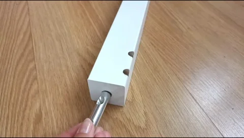 Assembly of a table leg using metal fasteners, connector pins Stock Footage 339180336