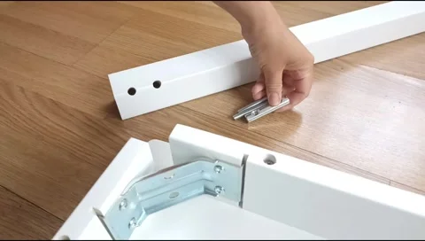 Assembly of a table leg using metal fasteners, connector pins Stock Footage 339180353