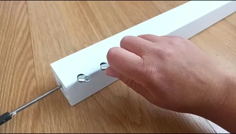 Assembly of a table leg using metal fasteners, connector pins Stock Footage 339180354