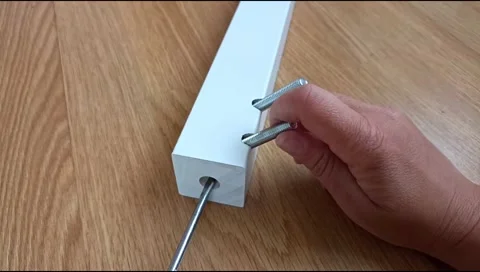 Assembly of a table leg using metal fasteners, connector pins Stock Footage 339180420
