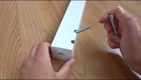 Assembly of a table leg using metal fasteners, connector pins Stock Footage 339180434