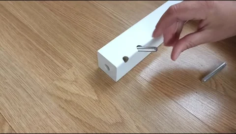 Assembly of a table leg using metal fasteners, connector pins Stock Footage 339180461