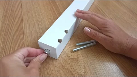 Assembly of a table leg using metal fasteners, connector pins Stock Footage 339180568
