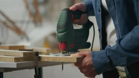Assembly, White woman In progress Cutting wood with a jigsaw, In slow motion Vídeos de archivo 239645675