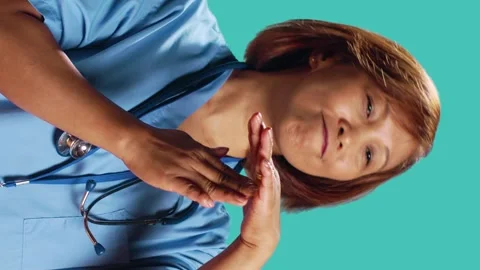 Assertive asian nurse asking for timeout Video stock 244815820