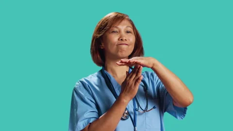 Assertive asian nurse asking for timeout Stock Footage 247472774