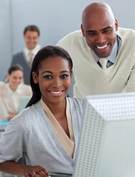 Assertive business partners working at a computer Stock Photos