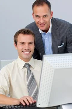 Assertive business partners working together at a computer Stock Photos