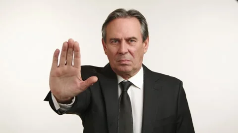Assertive Businessman in Dark Suit Making Stop Gesture 스톡 동영상 261169598