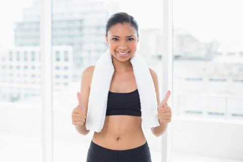 Assertive dark haired model in sportswear giving thumbs up Stock Photos
