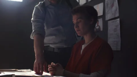 Assertive Investigator Pointing to Documents and Interrogating Female Inmate 스톡 동영상 311202660