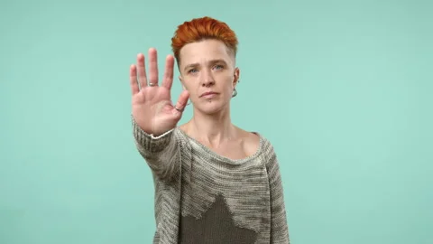 Assertive Lesbian Showing Stop Gesture with Outstretched Hand to Camera Stock Footage 263810304