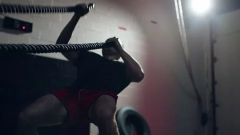 Assertive man doing exercises with battle rope, ruthlessly effective workout. Stock Footage 155659925